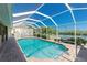 Sparkling screened-in pool with lush tropical landscaping and waterfront views at 1374 Grebe Dr, Punta Gorda, FL 33950