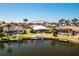 Backyard features a dock on the canal with lush landscaping and a screen enclosure at 1374 Grebe Dr, Punta Gorda, FL 33950