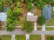 Aerial view of a well-maintained home with mature trees, landscaping, driveway, and street view at 1510 Orlando Blvd, Port Charlotte, FL 33952