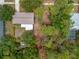 An aerial view showing the roof and treed backyard of the property at 1510 Orlando Blvd, Port Charlotte, FL 33952