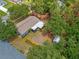 Aerial view showcasing the home nestled among lush greenery with an outdoor shed and patio area at 1510 Orlando Blvd, Port Charlotte, FL 33952