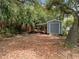 Spacious backyard featuring a utility shed with a covered side porch area at 1510 Orlando Blvd, Port Charlotte, FL 33952