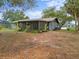 View of the screened in porch in the backyard with mature trees at 1510 Orlando Blvd, Port Charlotte, FL 33952