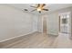 Bedroom with light wood floors, ceiling fan, and doors to the closet and bathroom at 1510 Orlando Blvd, Port Charlotte, FL 33952