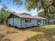 Exterior elevation with manicured landscaping, mature trees, and a well-maintained yard at 1510 Orlando Blvd, Port Charlotte, FL 33952