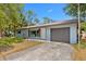 Charming single-story home featuring an attached garage and a front yard at 1510 Orlando Blvd, Port Charlotte, FL 33952