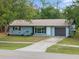 Inviting single-story home with well-maintained landscaping, a driveway, and an attached garage at 1510 Orlando Blvd, Port Charlotte, FL 33952
