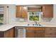 Well-lit kitchen featuring stainless steel sink, modern countertops and dark brown cabinets at 1510 Orlando Blvd, Port Charlotte, FL 33952