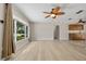 Bright living room featuring wood floors, a ceiling fan, and ample natural light at 1510 Orlando Blvd, Port Charlotte, FL 33952