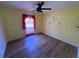 Neutral bedroom featuring wood flooring, a window with curtains, and ceiling fan at 16072 Galiano Ct, Punta Gorda, FL 33955