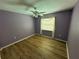 Neutral bedroom featuring wood flooring, a window with curtains, and ceiling fan at 16072 Galiano Ct, Punta Gorda, FL 33955