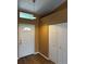 Inviting entryway featuring a front door with half-moon window and wood-look flooring at 16072 Galiano Ct, Punta Gorda, FL 33955