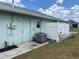 Back door with AC and white privacy fence detail on a sunny day in Florida at 16072 Galiano Ct, Punta Gorda, FL 33955