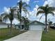 Charming single-story home with a well-manicured lawn and swaying palm trees at 16072 Galiano Ct, Punta Gorda, FL 33955