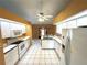 Functional kitchen equipped with white cabinets, appliances, and tiled floor at 16072 Galiano Ct, Punta Gorda, FL 33955