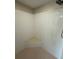 Neutral colored shower with neutral tiling, shower head, and inset shelf at 16072 Galiano Ct, Punta Gorda, FL 33955