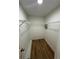 Walk-in closet with wood-look floors and wire shelving for organized storage at 16072 Galiano Ct, Punta Gorda, FL 33955