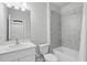 Bathroom featuring a tub and shower combo with modern tilework, alongside a stylish white vanity at 16079 Bandermill Dr, Port Charlotte, FL 33953