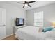 Comfortable bedroom with ceiling fan, window view and television and white bedding at 16079 Bandermill Dr, Port Charlotte, FL 33953