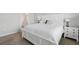 A bright bedroom with an ornate headboard, with large bedside tables, and bright white bedding at 16079 Bandermill Dr, Port Charlotte, FL 33953