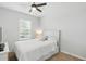 Bright bedroom with a cozy bed and bright light coming from a window with white blinds at 16079 Bandermill Dr, Port Charlotte, FL 33953