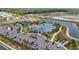 Aerial view of the community center featuring a pool, tennis courts, and parking at 16079 Bandermill Dr, Port Charlotte, FL 33953