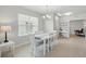 The dining area has a white table set, bright natural light, and easy access to other spaces at 16079 Bandermill Dr, Port Charlotte, FL 33953