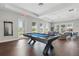 This game room features a billiards table and a comfortable seating area for relaxed entertainment at 16079 Bandermill Dr, Port Charlotte, FL 33953