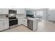 Bright kitchen featuring white cabinets, quartz countertops, and stainless steel appliances at 16079 Bandermill Dr, Port Charlotte, FL 33953