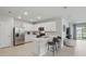Modern kitchen with white cabinetry, stainless steel appliances, and a convenient breakfast bar at 16079 Bandermill Dr, Port Charlotte, FL 33953