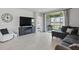 Comfortable living room featuring tile floors and access to the screened patio with beautiful views at 16079 Bandermill Dr, Port Charlotte, FL 33953