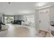 Bright, open-concept living space with modern tile flooring, and a sliding glass door to the outside at 16079 Bandermill Dr, Port Charlotte, FL 33953