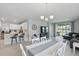 Open-concept living space with modern kitchen, dining area, and comfortable living room setup at 16079 Bandermill Dr, Port Charlotte, FL 33953