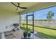 Screened patio with brick flooring, seating, grill, and a view of the lake at 16079 Bandermill Dr, Port Charlotte, FL 33953