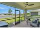 Screened patio with brick flooring, seating and a view of the lake at 16079 Bandermill Dr, Port Charlotte, FL 33953