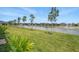 Backyard pond view with newly planted trees and a fountain feature at 16079 Bandermill Dr, Port Charlotte, FL 33953