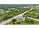 An aerial view of a single-Gathering home featuring a private pool and green, lush landscaping at 17210 Chase Ave, Port Charlotte, FL 33948