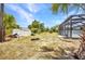 Exterior backyard shot with shed and pool enclosure with lots of green space at 17210 Chase Ave, Port Charlotte, FL 33948