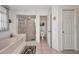 Bathroom featuring a jacuzzi tub, shower, toilet, and linen closet at 17210 Chase Ave, Port Charlotte, FL 33948