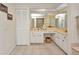 Light and bright bathroom with tile floor, double sinks, and ample cabinet space at 17210 Chase Ave, Port Charlotte, FL 33948