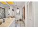 Well-lit bathroom with a large vanity, ample storage, and a combined shower-tub at 17210 Chase Ave, Port Charlotte, FL 33948