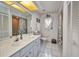 Bright bathroom features a wide mirror, spacious vanity, and a combined shower-tub at 17210 Chase Ave, Port Charlotte, FL 33948