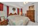A bright bedroom featuring a comfortable bed, natural light, and classic wooden furniture at 17210 Chase Ave, Port Charlotte, FL 33948