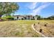 Charming one-story home with well-kept lawn, mature trees, and beautiful landscaping at 17210 Chase Ave, Port Charlotte, FL 33948