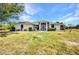 A charming single-story home features a well-maintained lawn and a welcoming entrance, perfect for a serene living at 17210 Chase Ave, Port Charlotte, FL 33948