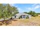 A front view of a well-maintained single-Gathering home with lawn and mature trees at 17210 Chase Ave, Port Charlotte, FL 33948