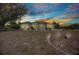 An evening view of a single-Gathering home with manicured lawn and attractive landscaping at 17210 Chase Ave, Port Charlotte, FL 33948