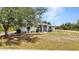 Charming home featuring lush landscaping, a mature shade tree, and inviting front porch at 17210 Chase Ave, Port Charlotte, FL 33948