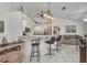 Open kitchen with bar seating, modern lighting, and a view into the adjacent living area at 17210 Chase Ave, Port Charlotte, FL 33948