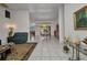 Spacious living area featuring elegant furnishings, tile flooring, and an open layout, providing a bright and inviting space at 17210 Chase Ave, Port Charlotte, FL 33948